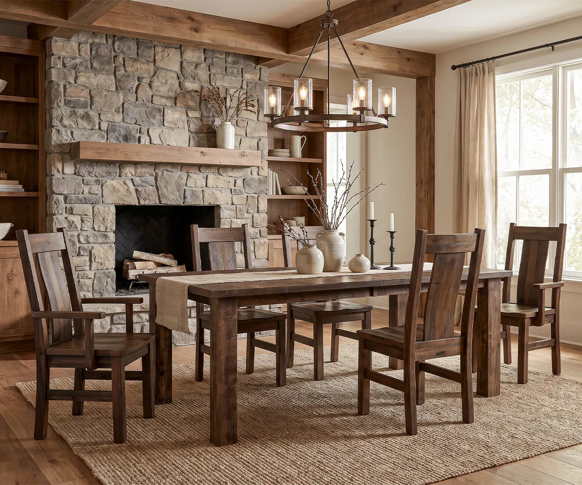 Amish-built solid wood dining table and chairs by a stone fireplace